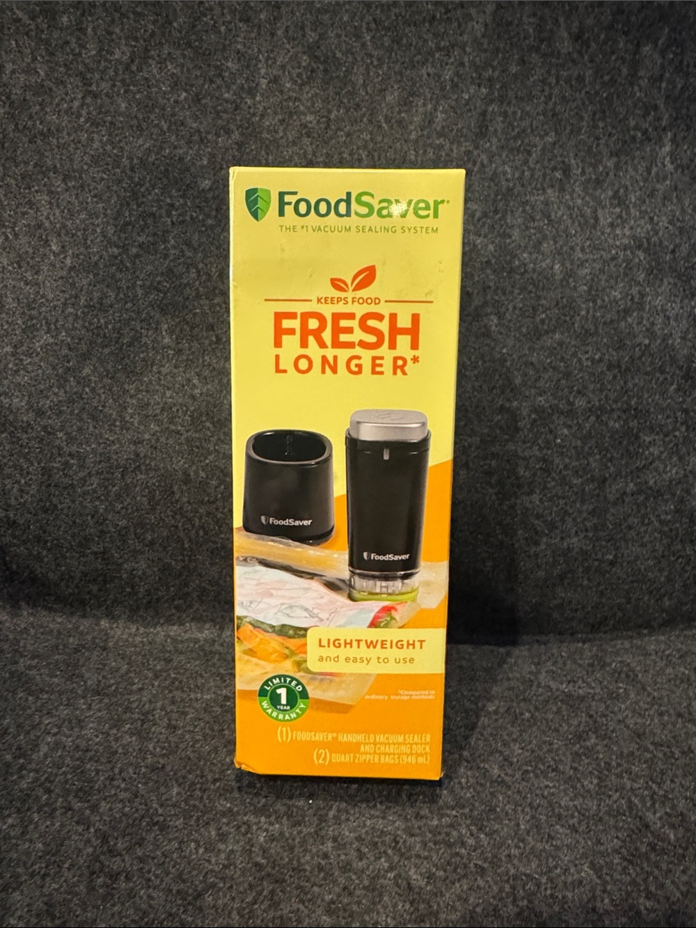 FoodSaver handheld vacuum sealer and charging dock. New in box. Never opened.